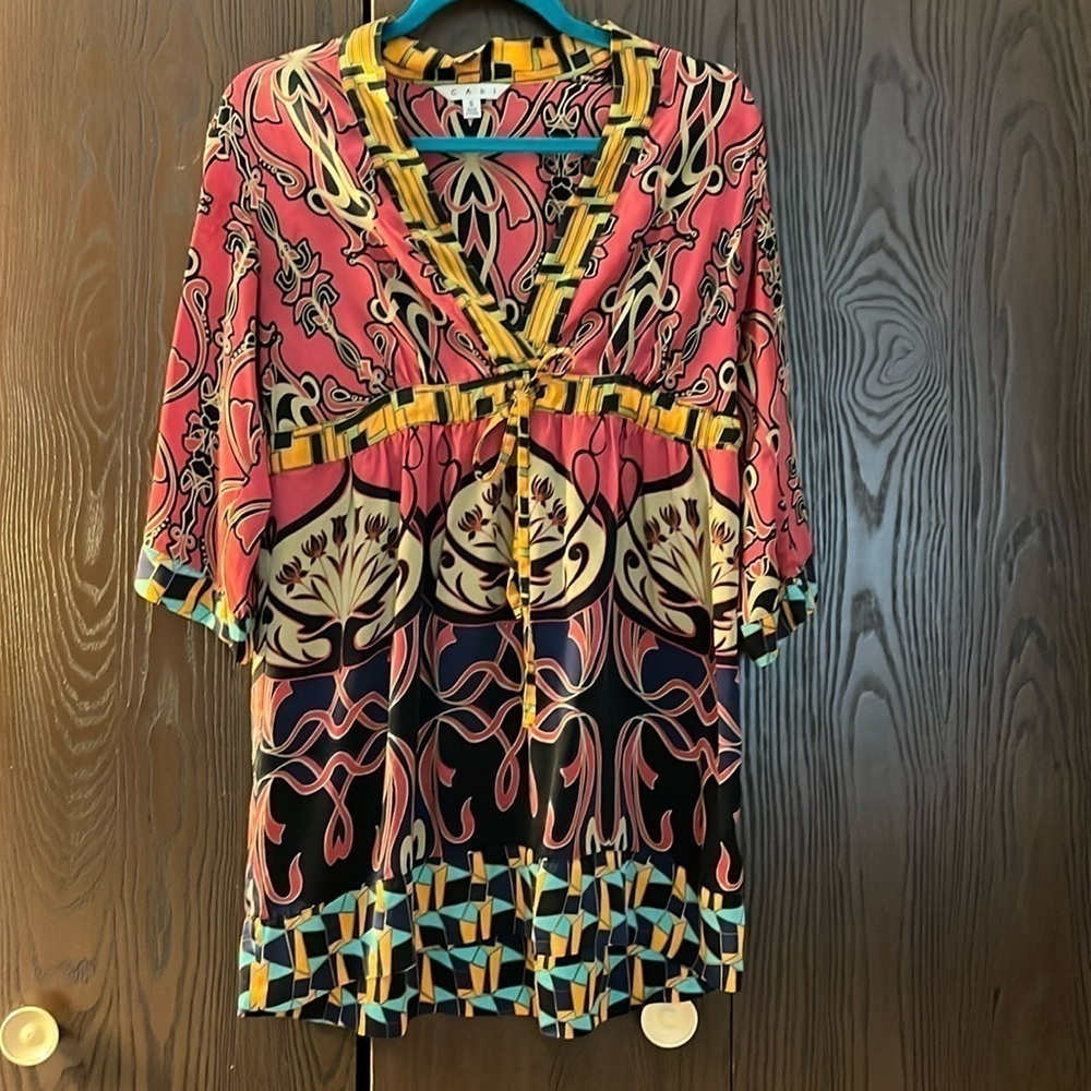 Cabi 100% silk top. 3/4 sleeved. Tie at the waist. Size Small